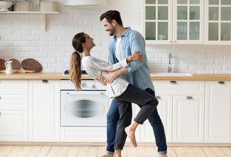 Happy couple dancing in the kitchen