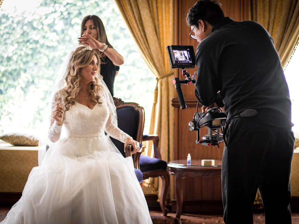 Videographer filming bride