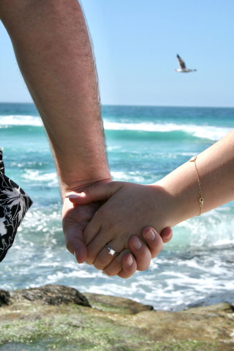 After Ellie said yes, they reveled in the perfect moment, dancing and embracing. Christopher then whispered, "My parents are here." As Ellie turned around, she spotted Ted and Laura across the beach, hiding behind the rocks with a camera in hand, beaming from ear to ear.
