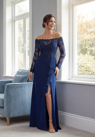 Elegant and effortlessly flattering, this Stretch Soft Crepe fit-and-flare gown is a sophisticated choice for the Mother of the Bride. The embroidered lace top features a portrait neckline and off-the-shoulder long sheer lace sleeves, creating a romantic and refined silhouette. The natural waistline flows into a graceful skirt with a front slit accented by a delicate ruffle, adding subtle movement and modern charm. This gown combines timeless elegance with contemporary details for a look that is both striking and stylish.