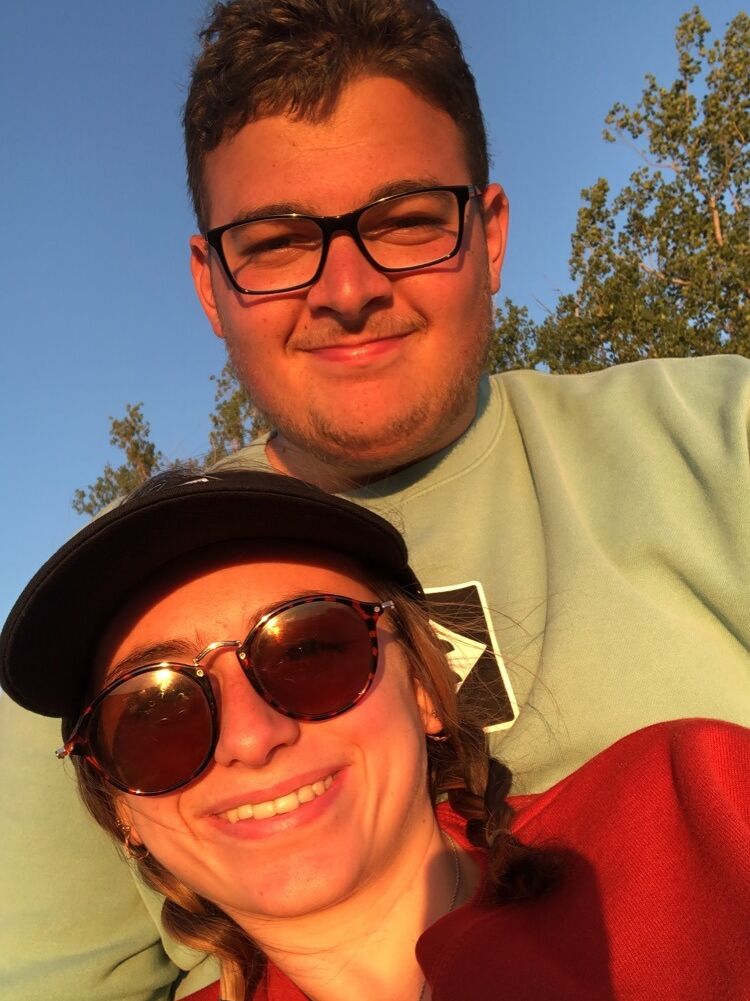 In August of 2020, Becca and Thomas took to the road and headed up north to Glen Arbor, Michigan, where Thomas and his family had visited many years prior. Thomas was excited to show Becca everything there was to see, from the Sleeping Bear Dunes to the lazy river and everything in between. New to them both was where they stayed: a cozy little B&B with quaint bedrooms, a shared bathroom and unique homemade breakfast that was prepared daily. On one of the evenings, Thomas took Becca up the dunes to a spot where we could view the sunset. There was an overlook he wanted to take her that he and his family would go to watch the sunset every time they visited, but it was closed due to the construction. Instead, they sat in the sand at the top of the dunes, among the tall weeds and watched intertwined as the sun fell below the dunes. As Becca watched the weeds sway in the breeze and the sun creep lower, everything became golden and her whole body filled with warmth. It was in that moment she felt complete awareness of every thing around her. All her hairs stood up and her heart was racing, the way it does when you realize you're experiencing something important and fleeting. And with all that, and being in Tom's arms, she felt complete safety and complete peace. She looked up at Thomas and said, “if you asked me to marry you right here right now, I would”. Thomas did not in fact ask Becca this question in that moment, which was good as they were just babies. Instead, he smiled and kissed Becca, all while filing away that note for later…