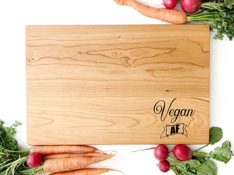 Wooden cutting board with 'Vegan AF' in black type in bottom corner