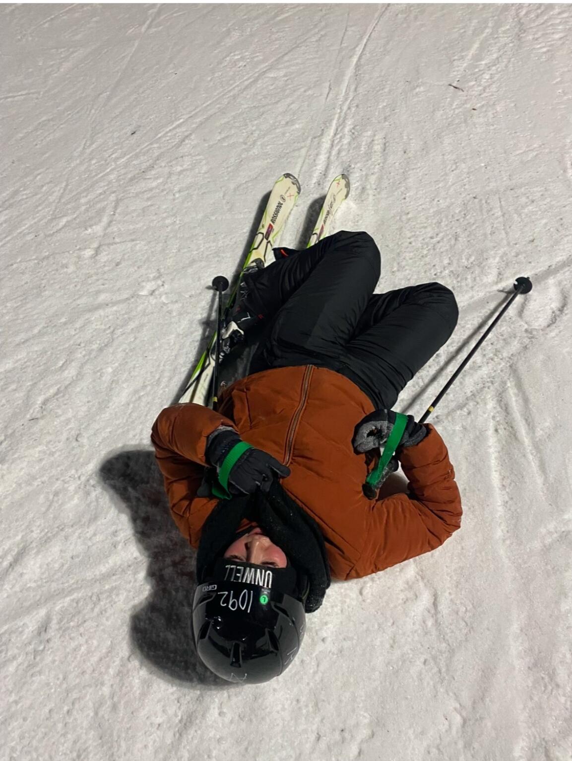 Dani wiping out after skiing backward down the bunny hill