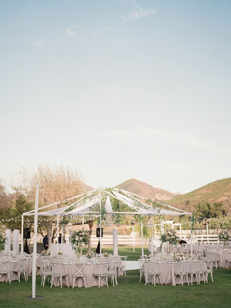Open-air wedding reception tent at barn venue