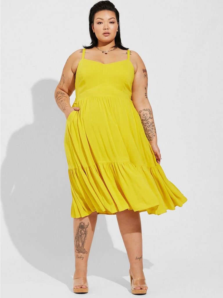 Model wears a lemon yellow dress. 