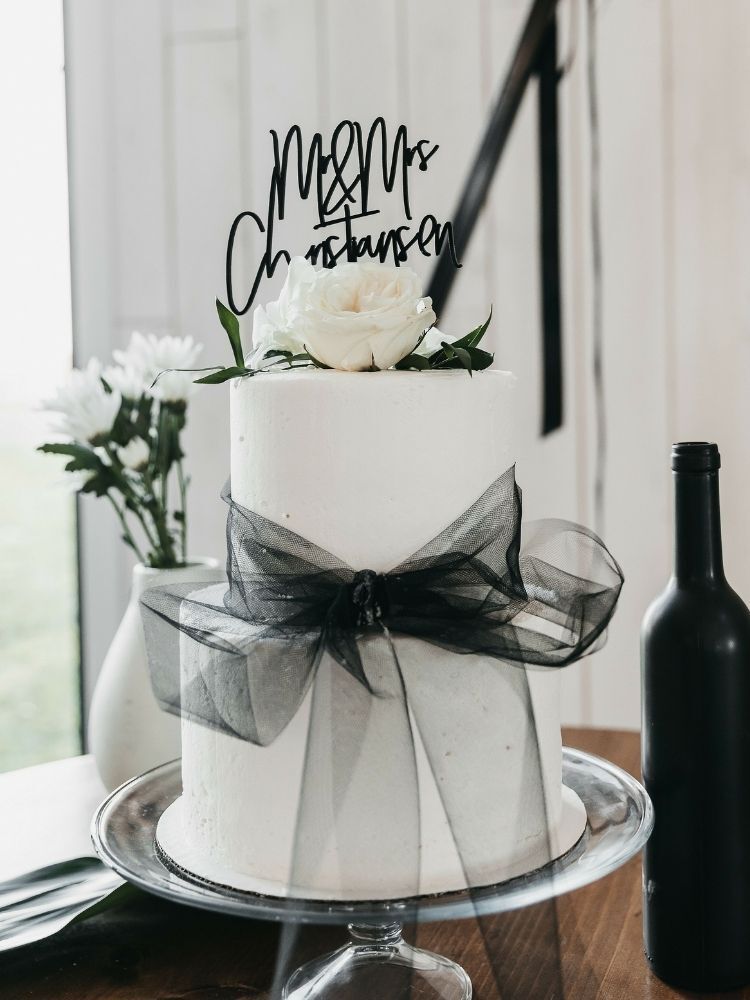 white wedding cake with black cake topper