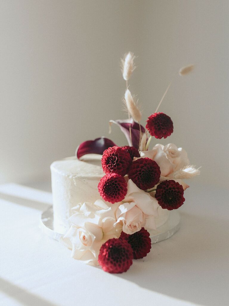 Gorgeous dark red dahlia and white rose wedding cake