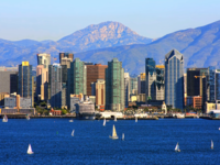 San Diego skyline from bay with mountains in background.