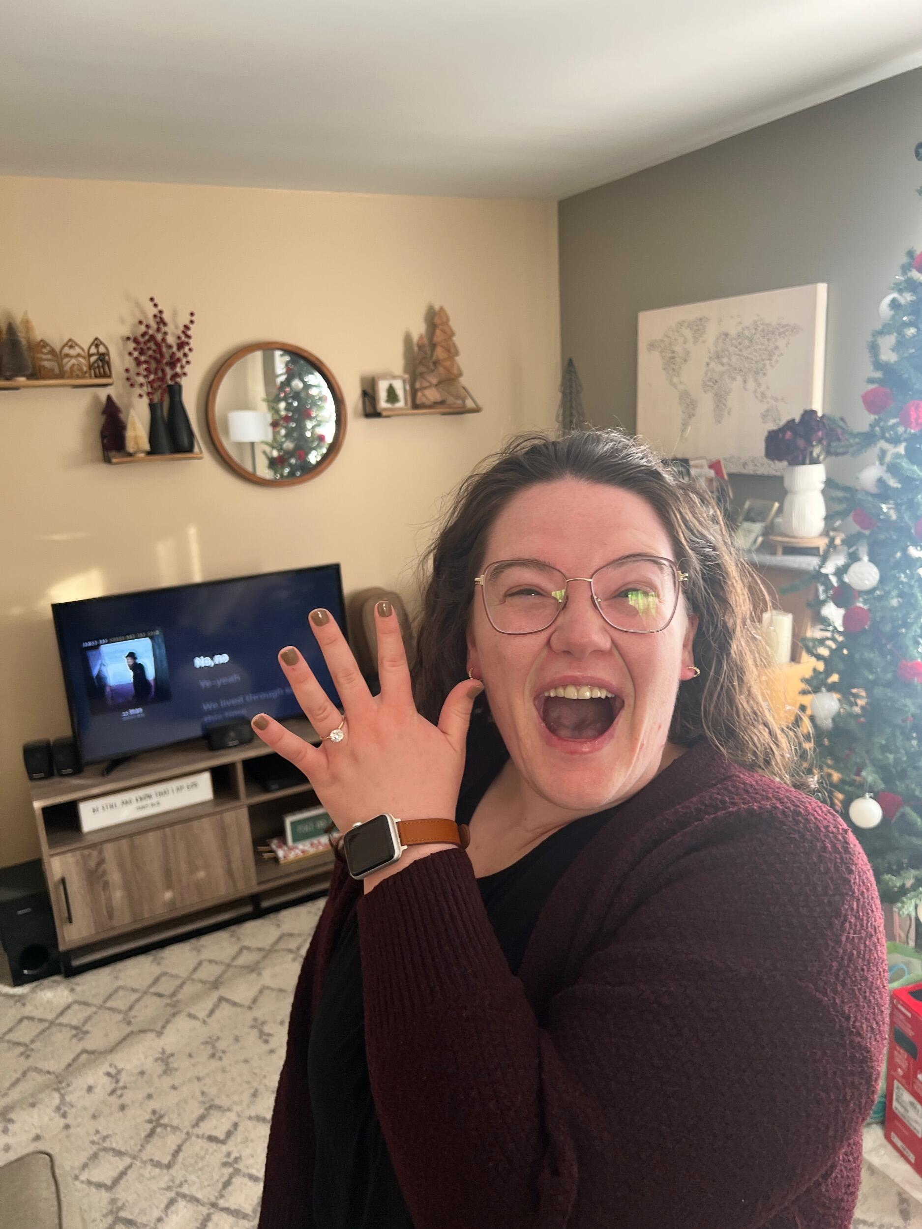 Austin proposed to Lauren in her living room with 5 dozen roses. She said YES!