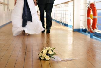 Bride and groom walking the deck of a ship