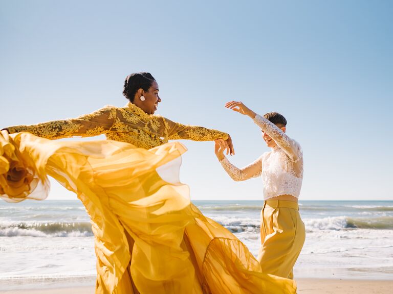 Couple dancing on the beach with coordinating yellow and lace outfits