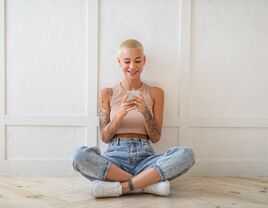 Happy lady using smartphone texting and browsing internet