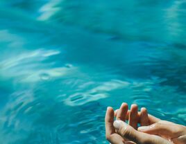 Hands in water, suggesting a relaxing sunny day