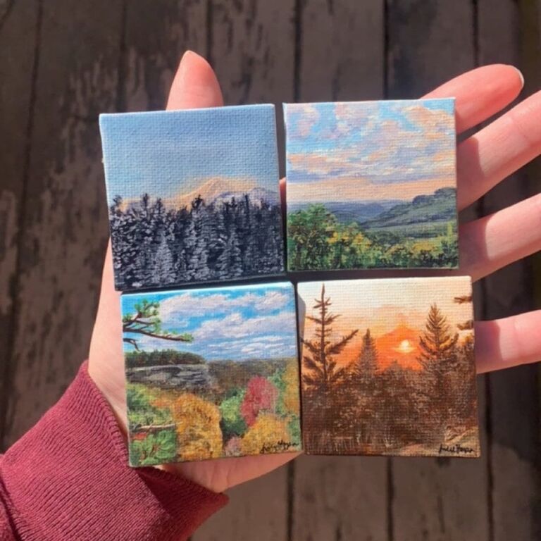 Four tiny paintings of landscaped in palm of hand