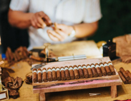 Cigar roller vendor making cigars at wedding