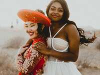 Brides hugging on wedding day