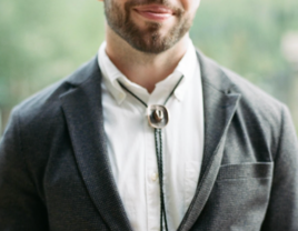 Man wearing cowboy hat bolo tie at wedding