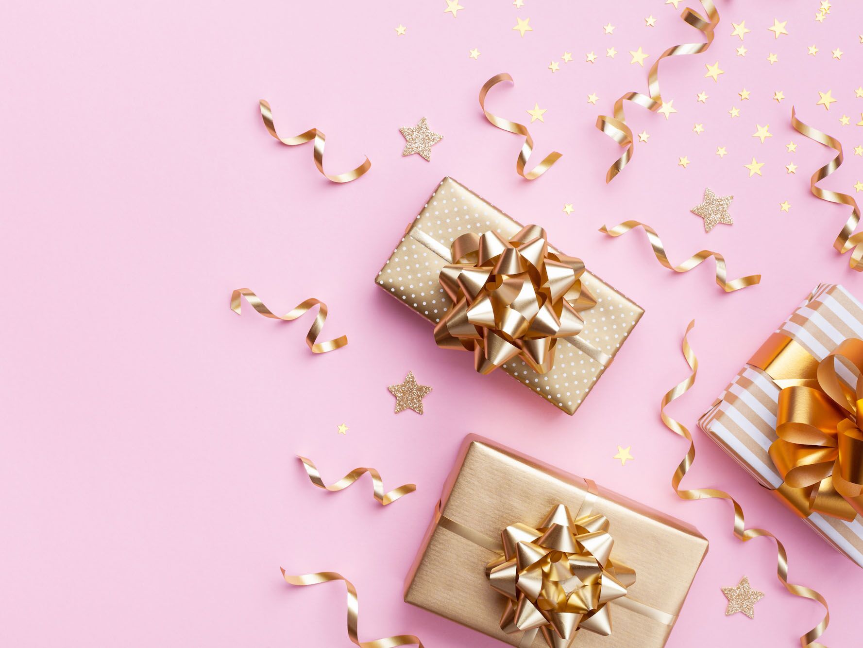 Gold presents on a pink background