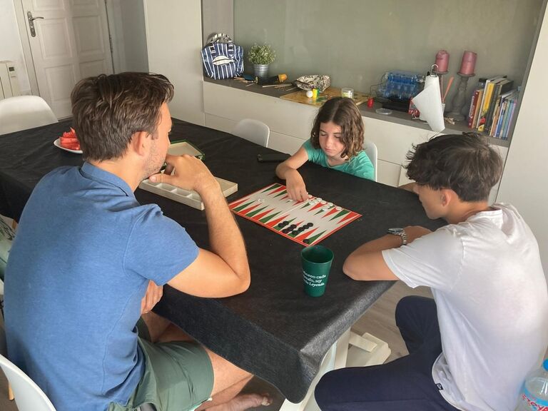 Getting the chicos into the backgammon game - thankfully they're just as competitive as we are!