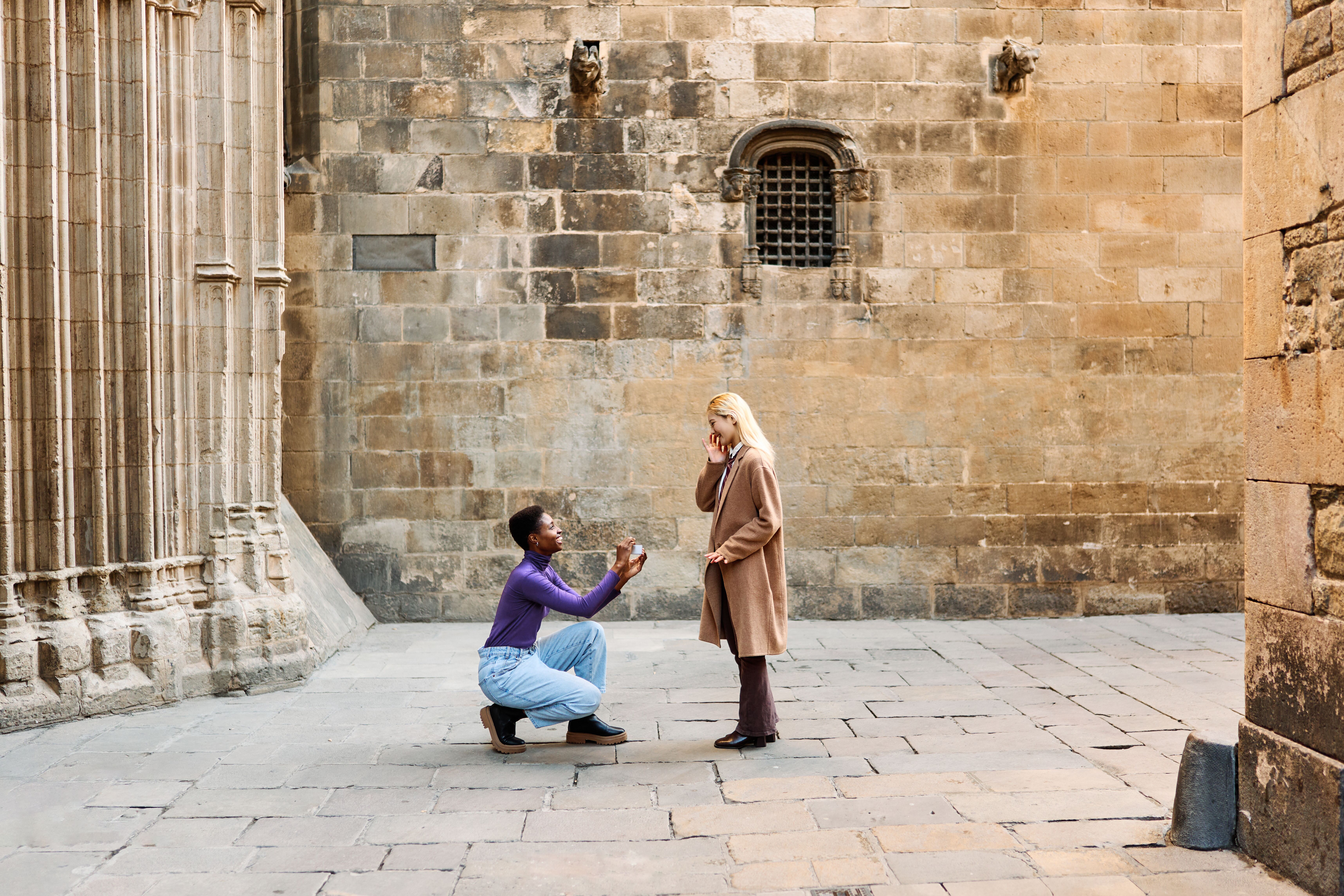 Woman proposing to her fiancée outside