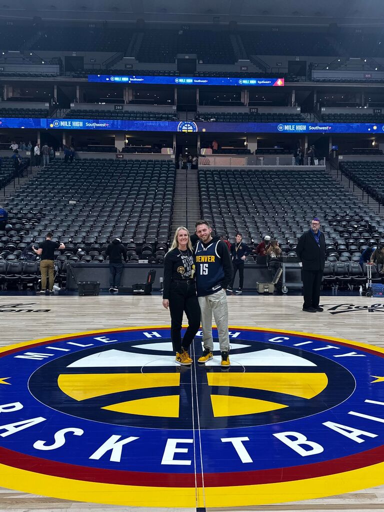 Took advantage of our season tickets to the Nuggets with a photo on the court!