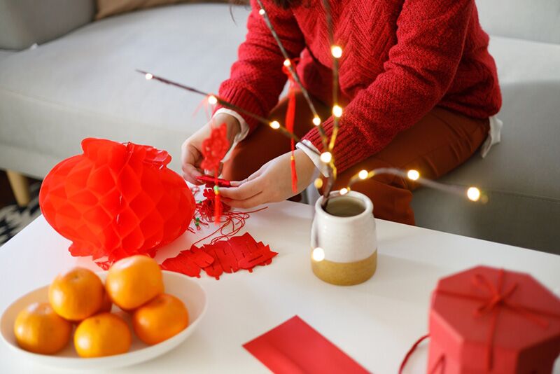 Chinese woman making decorations for Lunar New Year party