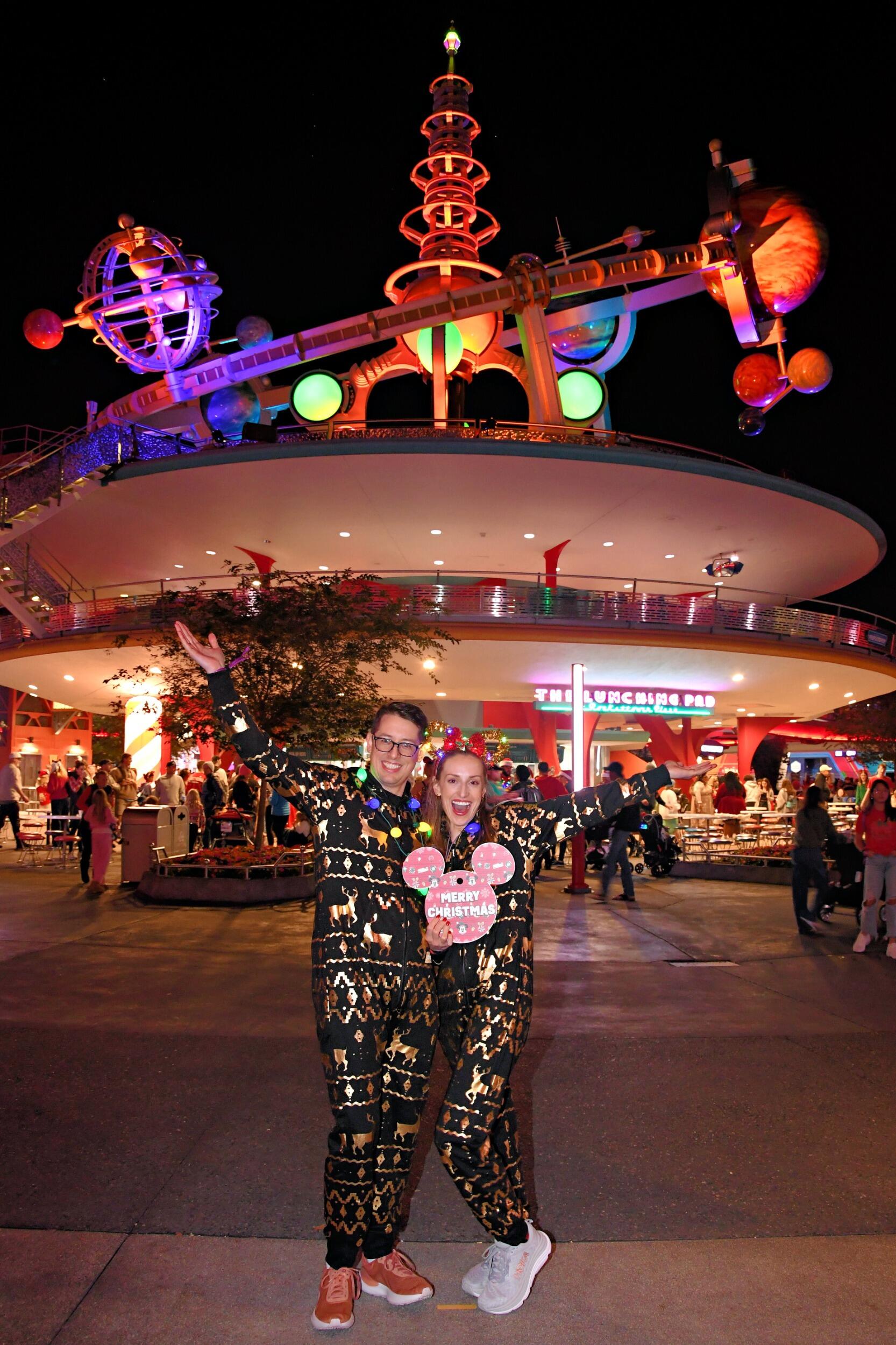 Kirsten and Tyler attend Mickey's Very Merry Christmas Party at Magic Kingdom. They wear matching Christmas onesies and are a huge hit with parkgoers and employees alike.