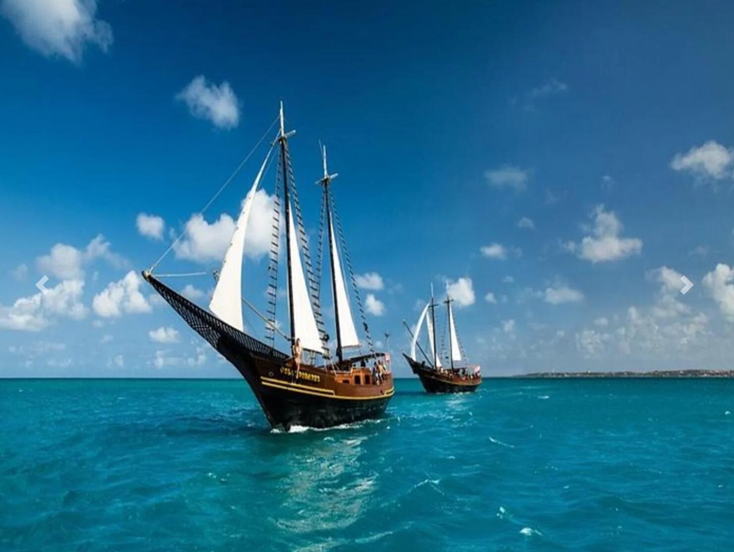 Join us on the JOLLY ROGER PIRATE SHIP! 
      Time: 1:30 pm-5 pm 
      Location: The boat will set sail from Hadicurari Beach. 
      Attire: Bathing suits & cover-ups 
Details: Swim or snorkel, sip drinks from the open bar, and try out the rope swing on this three-hour Aruba pirate ship tour. Transportation included above. All guests MUST sign the waiver prior to the boat trip. See the waiver link at the top of the page.
              Drinks: The Jolly Pirates open bar includes locally bottled Rum, Gin, Vodka, Bourbon, Scotch, white wine blends, and red wine blends.  Fresh water and an assortment of juices and sodas are included. The ship’s specialty brew, Pirates Poison, and Captain’s Colada, Rum Punch are also served aboard.  
