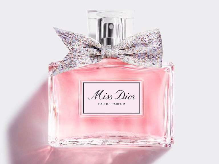 Bottle of Miss Dior perfume with a bow around the nozzle wedding gift for sister