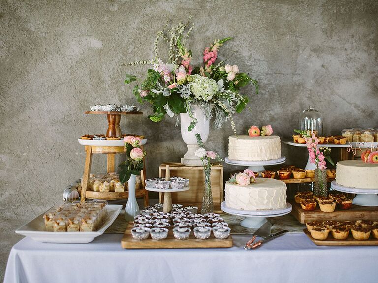 wedding dessert spread decorated with flower arrengement