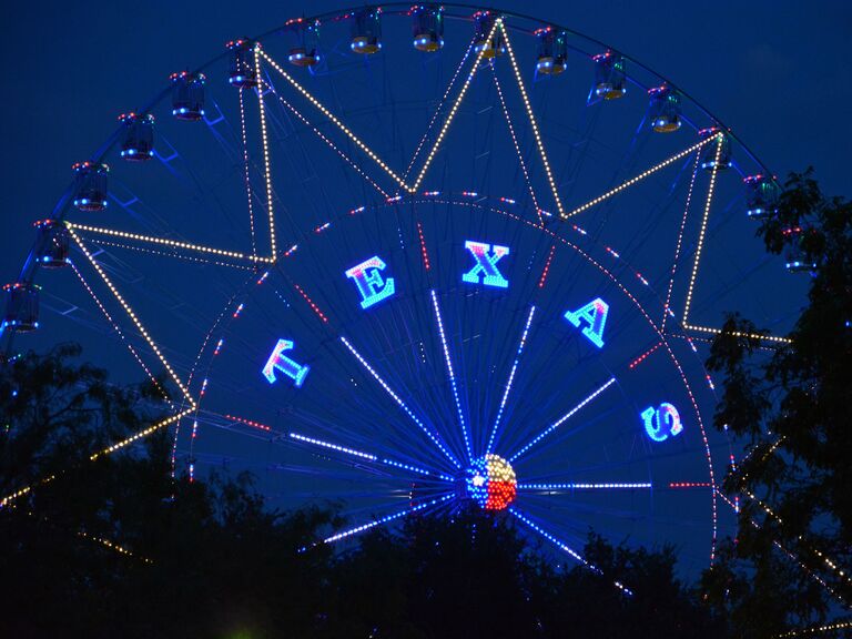 Ferris wheel lit up with letters spelling Texas