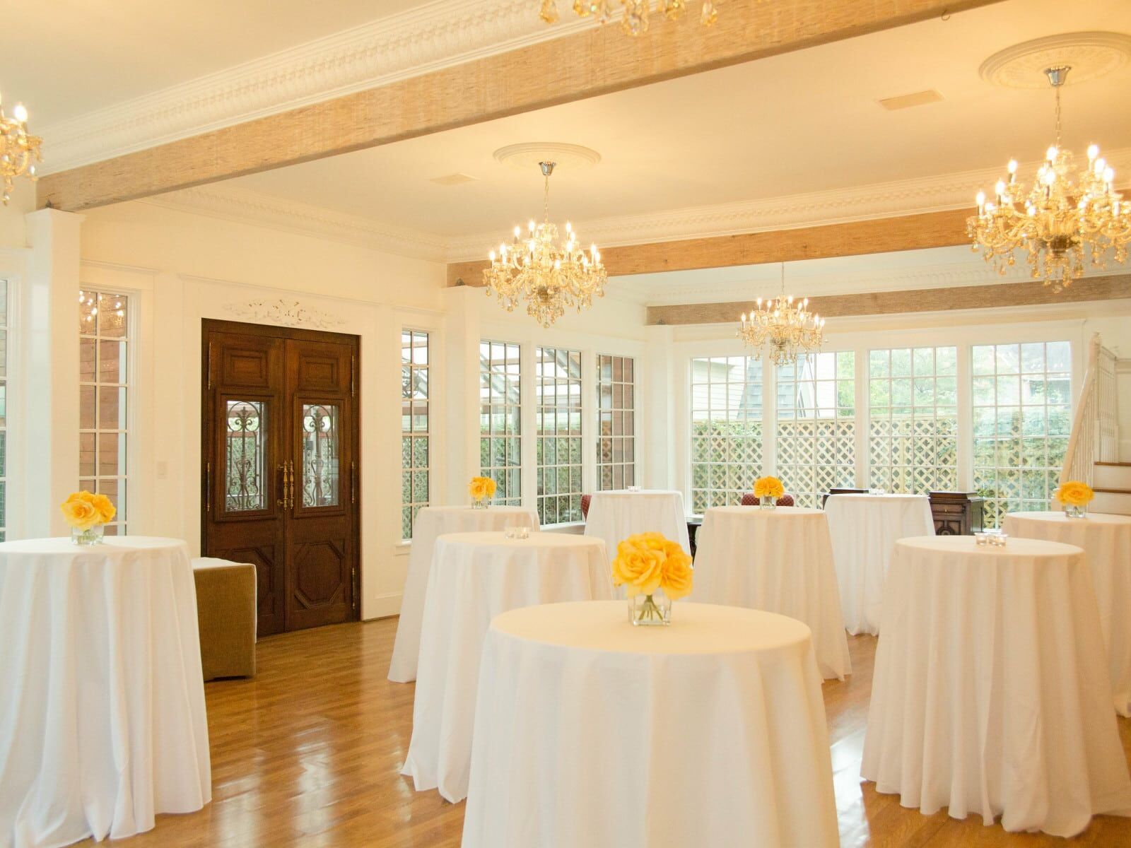 Sara’s Inn white tables with yellow flowers