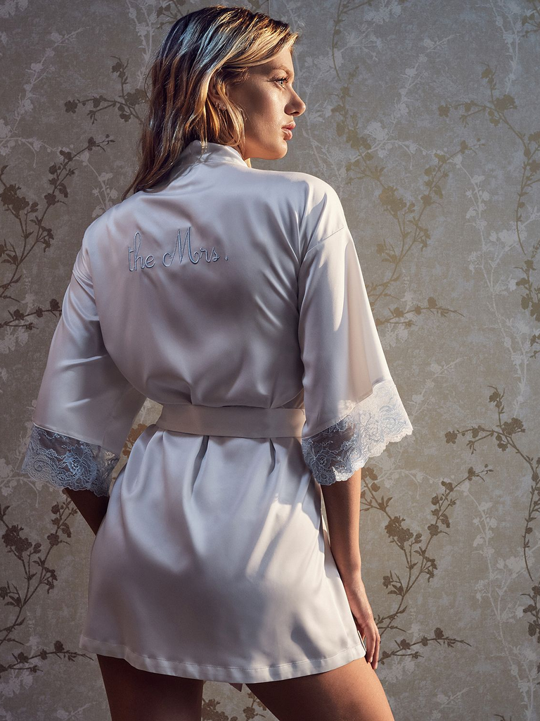 A model showing off "The Mrs." Wrap Robe, with its lacey elbow-length sleeves.