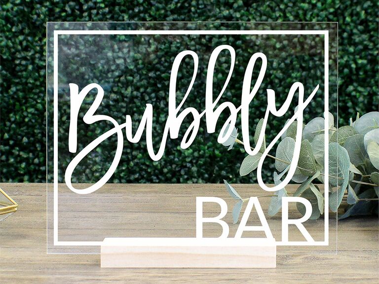 Acrylic sign with 'Bubbly Bar' in white type and white rectangle border