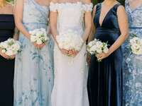 bride with bridesmaids in light blue and navy blue mix-and-match dresses