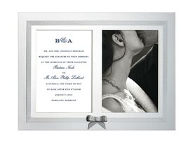 Silver wedding picture frame with invitation and photo of couple