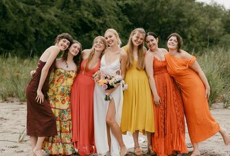 Beach wedding ceremony guests' attire with bride