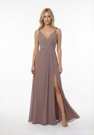 Step into modern romance with this effortlessly chic bridesmaid dress. Crafted from lightweight Poly Chiffon with a smooth Stretch Lining, this gown features delicate spaghetti straps accented with subtle floral details for a fresh, on-trend feel. Soft gathers across the bodice create a flattering, contoured look, while the flowing skirt brings easy movement and elegance. Finished with a front slit for a confident, contemporary edge, this dress is perfect for bridesmaids who love elevated style with a playful twist.