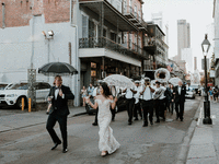 Newlyweds doing second line Southern wedding tradition. 