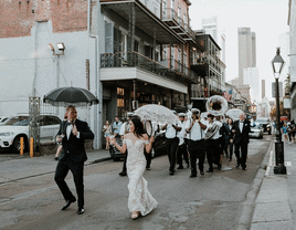 Newlyweds doing second line Southern wedding tradition. 