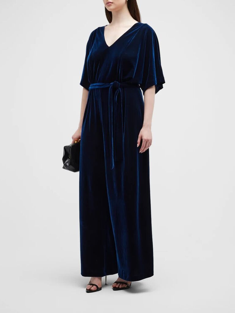 Velvet wide leg jumpsuit in navy with V neckline and a velvet belt from Neiman Marcus