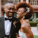 Bride and groom laughing with each other