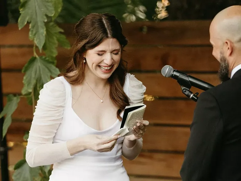Bride in Modern Gown Getting Emotional Reading Vows From Book