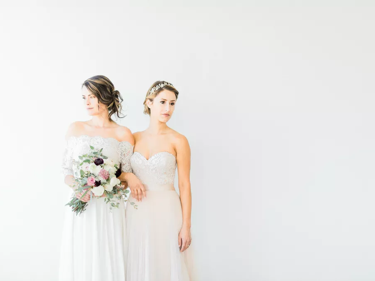 Two brides wear wedding dresses from Blue Bridal Boutique