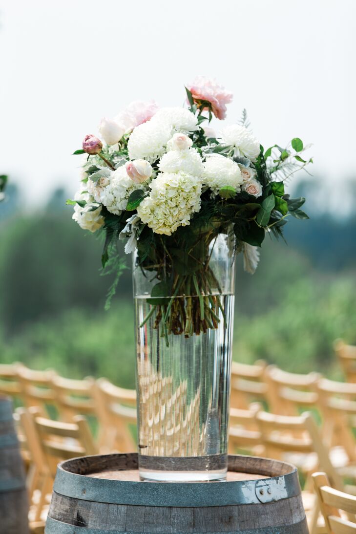 Neutral Floral Aisle Decor On Rustic Barrel