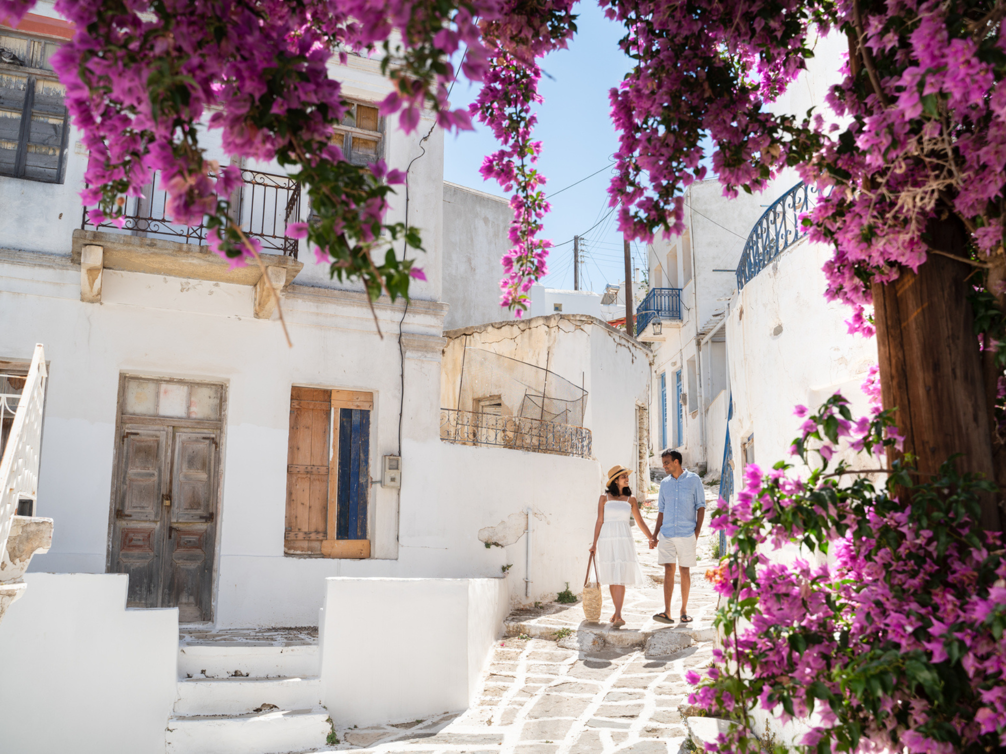 Couple walking and holding hands in Greece