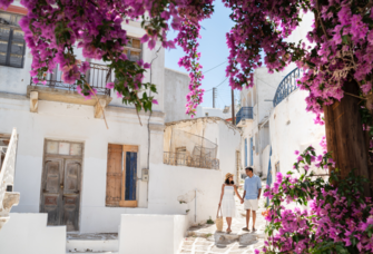 Couple walking and holding hands in Greece