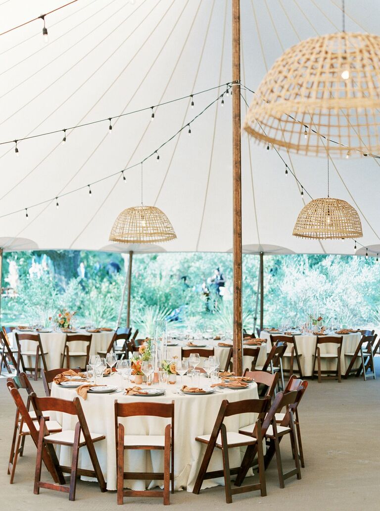 Tented reception with woven chandeliers and wood folding chairs