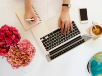 Woman working on laptop making a checklist