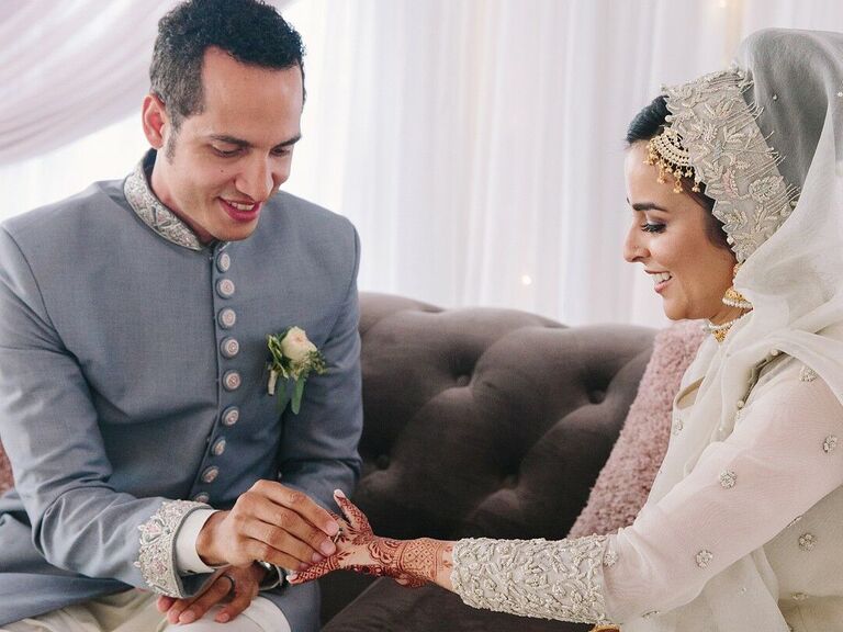 Couple exchanging rings during muslim ceremony.